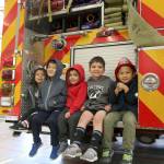 Kids at the Fire Departments open house sit together on the back of a Fire Engine. From left: Olivia Chan, Aiden Chan, Philip Farah, James Farah, and Austin Vo. Evan Pappas/Staff Photo