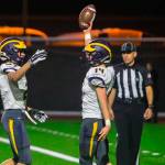 Bellevue Wolverines running back Alex Reid, right, celebrates after scoring a touchdown against the Mercer Island Islanders on Oct. 26. Bellevue defeated Mercer Island 47-0 in the regular season finale. Photo courtesy of Don Borin/Stop Action Photography