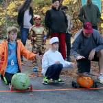 Best Decorated Pumpkin winner Sam Patton, left, and duo Joseph and Sean Cronkite, right, send their pumpkins down the hill as part of the Great Pumpkin Race held at the South Bellevue Community Center on Oct. 27. Evan Pappas/Staff Photo