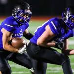 Bellevue Christian Vikings running back John Kim, center, battles for extra yardage against the Klahowya Eagles in the season finale on Nov. 3 at Sammamish High School in Bellevue. The Eagles defeated the Vikings 21-0, eliminating the Vikings from playoff contention. Photo courtesy of Rick Edelman/Rick Edelman Photography