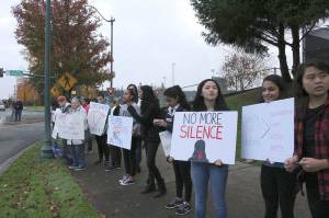 Skyline High School students and community protest perpetuation of rape culture following ISD lawsuit. Some signs read, Private Property with an image of a uterus. Another read, Blame rapists, NOT victims. another read, No More Silence. Madison Miller/staff photo.