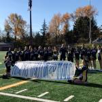 Bellevue Wolverines spotter Jay Honda (center with #64 jersey on) was honored for 20 years of volunteer service to the Bellevue Wolverines football program prior to the start of the Wolverines/Yelm Tornados Class 3A state quarterfinal matchup on Nov. 17 at Bellevue Memorial Stadium. The 2018 season was Hondas final season as the Wolverines spotter in the press box. Photo courtesy of the Bellevue Wolverines football program Twitter feed