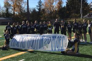 Bellevue Wolverines spotter Jay Honda (center with #64 jersey on) was honored for 20 years of volunteer service to the Bellevue Wolverines football program prior to the start of the Wolverines/Yelm Tornados Class 3A state quarterfinal matchup on Nov. 17 at Bellevue Memorial Stadium. The 2018 season was Hondas final season as the Wolverines spotter in the press box. Photo courtesy of the Bellevue Wolverines football program Twitter feed