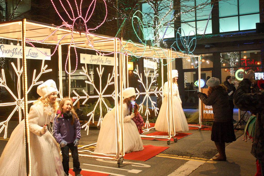 Snowflake Lane attendees can take photos with characters. Thousands of people visit Bellevue Way each winter to watch the live performance at 7 p.m. through Dec. 24. Reporter file photos