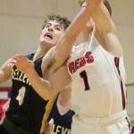 Bellevue player McCallum Mead, left battles Juanitas Nathan Robertson in the paint during a 3A KingCo contest on Dec. 4 at Juanita High School in Kirkland. The Wolverines defeated the Rebels 61-48 to improve their overall record to 1-1. Andy Nystrom, staff photo