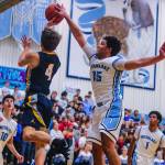 The Bellevue Wolverines earned a 44-37 victory against the Interlake Saints in a 3A KingCo basketball matchup on Dec. 7 at Interlake High School in Bellevue. Bellevue improved its overall record to 2-1 with the win while Interlake dropped to 1-2 with the loss. Interlake forward Myles Chandler, right, blocks Bellevue player McCallum Meads shot during the matchup between rival schools. Photo courtesy of Don Borin/Stop Action Photography
