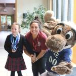From left, Frannie Ronan, 9, and St. Madeleine Sophie Catholic School principal Martine Romero pose with Mariner Moose on Dec. 13. Stephanie Quiroz/staff photo