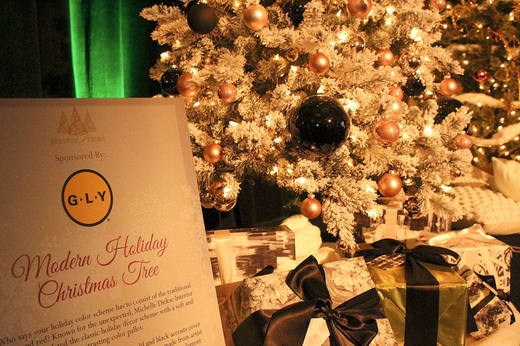Modern Holiday Christmas Tree, designed by Michelle Dirkse of Michelle Dirkse Interior Design was sponsored by GLY Construction. The 7.5 foot tree is a modern mix of warm blush tones with gold and black accents. Madison Miller/staff photo.