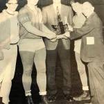 Former Bellevue Wolverines wrestling head coach Jim Richards (pictured in center with state championship trophy) is pictured with the Bellevue Wolverines 1963 state championship wrestling team. Bill Strickland (heavyweight), Noel McMurtry (135) and Roy Brewster (106) are pictured in the above photo.Image courtesy of Jim Richards.