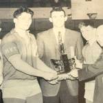 Former Bellevue Wolverines wrestling head coach Jim Richards (pictured in center with state championship trophy) is pictured with the Bellevue Wolverines 1963 state championship wrestling team. Bill Strickland (heavyweight), Noel McMurtry (135) and Roy Brewster (106) are pictured in the above photo.Image courtesy of Jim Richards.