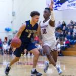 Bellevue Wolverines senior Jalen Love, left, dribbles down the court while being covered by Mercer Island guard Nigel Seda, right, during the 3A KingCo tournament championship game on Feb. 6. Love scored 12 of his 14 points in the second half of play. Mercer Island defeated Bellevue 44-41. Photo courtesy of Patrick Krohn/Patrick Krohn Photography
