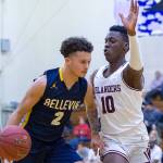 Bellevue Wolverines senior Jalen Love, left, dribbles down the court while being covered by Mercer Island guard Nigel Seda, right, during the 3A KingCo tournament championship game on Feb. 6. Love scored 12 of his 14 points in the second half of play. Mercer Island defeated Bellevue 44-41. Photo courtesy of Patrick Krohn/Patrick Krohn Photography
