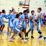 Interlake Saints players mob sophomore center Derek Kramer, right, following their dramatic 51-50 win against the Lake Washington Kangaroos in a loser-out playoff game on Feb. 6 at Newport High School in Factoria. Kramer hit two free throws with 5.7 seconds left in the game, giving his team a 51-50 lead. Photo courtesy of Don Borin/Stop Action Photography