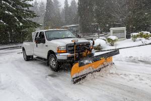 A plow removes snow from the Reporters parking lot in Factoria on Monday, Feb. 11. Ashley Hiruko/Staff photo