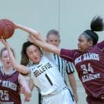 Bellevue Wolverines junior Kara Choi, center, controls the ball while being defended by Holy Names Academy Cougars players Bria Stokes, right, and Stefanie Hale, left. Holy Names earned a 49-48 victory against Bellevue in a loser-out game on Feb. 14 at Bellevue High School. Photo courtesy of Patrick Krohn/Patrick Krohn Photography
