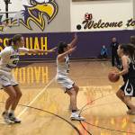 Bellevue Christian defenders Sophia Bold, center, and Molly Olson, left, converge on a Meridian senior Alexis Groen, right, in the first quarter of a regional playoff game on Feb. 23 at Issaquah High School. Meridian defeated Bellevue Christian 40-26. Shaun Scott, staff photo