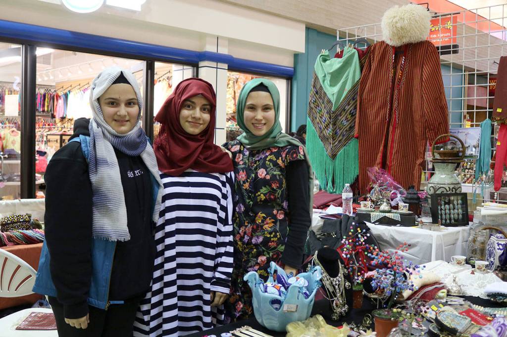 Volunteers from the Pacifica Institues culture center run a booth selling items made by members of the Turkish community, and items from Turkey. From left: Nihan Tatli, Busra Karabulut, and Fatima Camci. Evan Pappas/Staff Photo