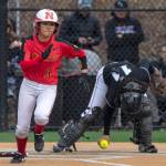 Newport Knights senior Alexis Khauv (pictured) hustles toward first base after laying down a bunt against the Bonney Lake Panthers on March 14 in Factoria. Photo courtesy of Patrick Krohn/Patrick Krohn Photography