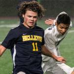 Bellevue junior Carson Wachter, left, carries the ball upfield while being chased by Interlake senior Cameron Rao in a matchup between 3A KingCo soccer rivals on April 10 in Bellevue. Wachter scored one goal in Bellevues 4-0 victory. Photo courtesy of Stephanie Ault-Justus