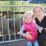 Stephanie Quiroz/staff photo                                 Claire Cannon and daughter Riley, 2, pose for a photo while enjoying the sheep at the annual sheep shearing event at Kelsey Creek Farm on April 27.