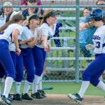Lake Washington players mob sophomore Maddie Miller after she connected on a two-run home run in the top of the sixth inning. Lake Washington defeated Bellevue, 12-5, in the 3A KingCo tournament championship game on May 10 at Inglemoor High School in Kenmore. Photo courtesy of Patrick Krohn/Patrick Krohn Photography