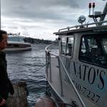 Corey Breuer, owner of Northwest Boat Disposal at Dunatos Boat Yard in Seattle shows a reporter one of three vessels which can lift sunken boats from King County waters and Puget Sound. Aaron Kunkler/staff photo
