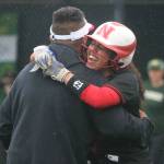 Newports Noelle Thomas gives coach Parris Mamon a hug after he cheered her up after being hit by a pitch. Andy Nystrom / staff photo