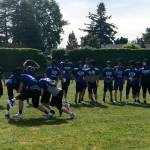 Bellevue Christian Vikings players partake in a tackling drill while Vikings head coach Todd Green, left, looks on during a spring practice on June 4. Shaun Scott/staff photo