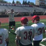 Newport Knights head football coach Drew Oliver gives his players advice on the importance of proper technique during a spring football practice session on June 10 in Factoria. Shaun Scott/staff photo