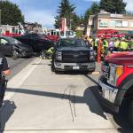 Car crash impact pushes truck into pedestrian