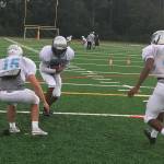 Interlake Saints football players participate in a tackling drill during a spring football practice session on June 19 in Bellevue. Shaun Scott/staff photo