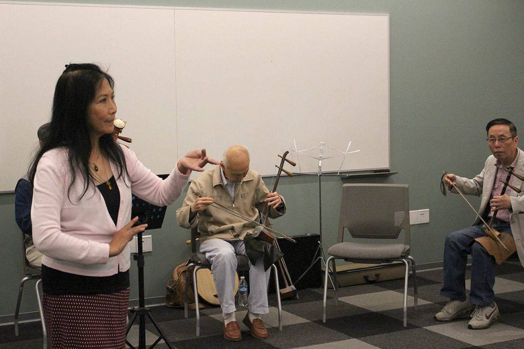 Mingzhu Jacobson, Binliang Wang, and Yabin Hu practice for Women in Times of War. Madison Miller / staff photo