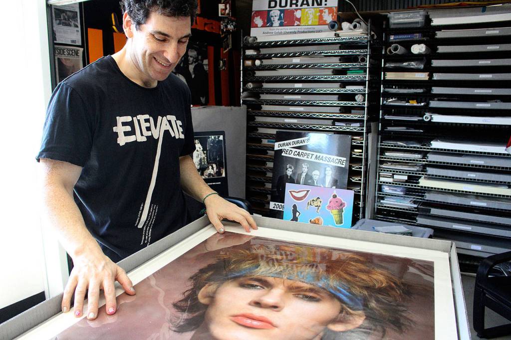 Andy Durandy Golub looks at a photo of his favorite Duran Duran member, Nick Rhodes. Madison Miller / staff photo                                Durandy showcases some of his more obscure collections including ads the band did for Japanese products. Madison Miller / staff photo