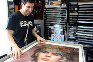 Andy Durandy Golub looks at a photo of his favorite Duran Duran member, Nick Rhodes. Madison Miller / staff photo