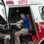 Bellevue firefighter Matt Egger (right) lets resident Peter Halcrow take a seat in a fire engine during National Night Out, on Aug. 6. During the event, responders from fire and police departments make visits to neighborhood gatherings around the city. Ashley Hiruko/staff photo