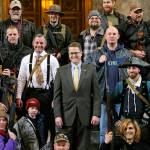 In this 2015 photo, Washington Rep. Matt Shea, R-Spokane Valley (center), poses for a group photo with gun owners inside the Capitol in Olympia, following a gun-rights rally. (AP Photo/Ted S. Warren, File)
