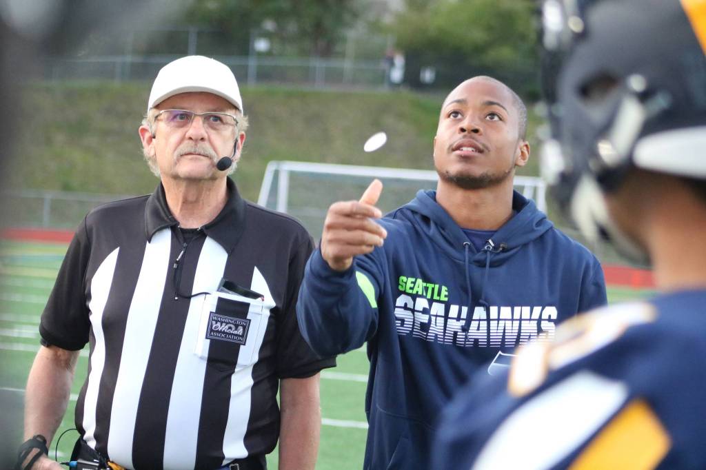 Seattle Seahawks wide receiver Tyler Lockett performs the coin toss before the game between Bellevue and Garfield on Sept. 20. Benjamin Olson/ staff photo
