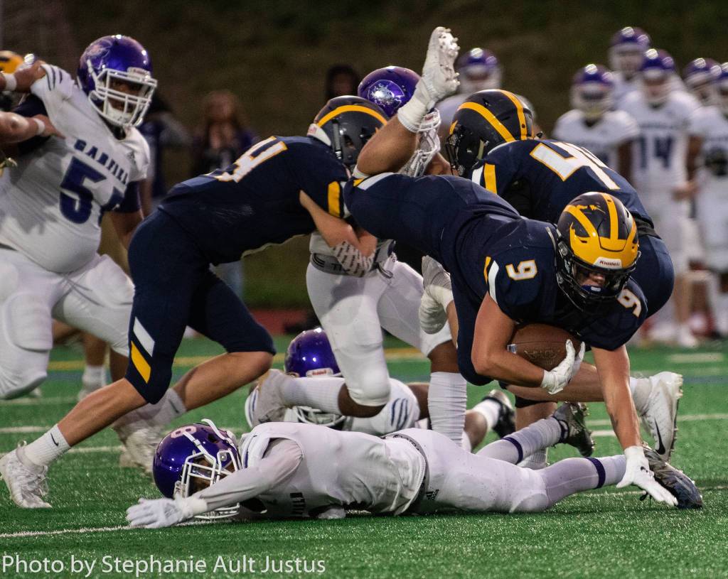 Bellevue running back Joby Schneider falls forward during the 28-27 Wolverine victory over Garfield on Sept. 20. Photo courtesy of Stephanie Ault Justus
