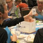 Table captain, Jill Perry, collects donations at the Providence Hospice of Seattles 20th annual pediatric luncheon on Sept. 19. Madison Miller / staff photo