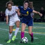 Bellevue midfielder Audrey Miller and Mercer Island midfielder Emily Yang fight for the ball during a 1-1 tie on Oct. 7. Photo courtesy of Stephanie Ault Justus