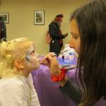 Isabelle Berube (left) gets her face painted by Saskia Visser at the Dia De Los Muertos celebration in downtown Issaquah. Samantha Pak/staff photo