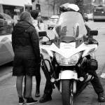 Ashley Hiruko/staff photos                                Above, Bellevue police held an exercise downtown on Dec. 10 to help educate motorists and pedestrians on the laws in place to ensure safety. As pedestrians crossed on red, they were pulled aside.                                 Below, Police leaders look down from above, giving directives to officers below. They waited to spot drivers and pedestrians disobeying the law.
