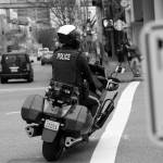 A Bellevue officer follows a car that turned on red without legally required amount of lane space. Motorists who did this were given a warning and educated on what driving law states. Ashley Hiruko/staff photo