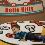 Two-year-old Chase Carlberg flops onto the plush Hello Kitty pizza at the Dec. 7 opening of the Hello Kitty Friends Around the World Tour Pop-Up in Bellevue. Madison Miller/staff photo