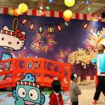 Madison Miller/staff photo                                Two-year-old Chase Carlberg flops onto the plush Hello Kitty pizza at the Dec. 7 opening of the Hello Kitty Friends Around the World Tour Pop-Up in Bellevue.