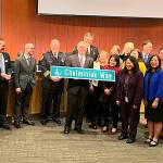 Council presented Mayor John Chelminiak a commendation, a plaque and his own street sign on Dec. 9. Photo courtesy of the City of Bellevue