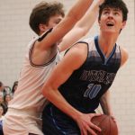 Interlake senior forward Cade Didrickson is guarded by Mercer Islands Lukas Varney. The Saints lost 61-36 to Mercer Island in the 3A KingCo tournament championship on Feb. 11. Benjamin Olson/staff photo