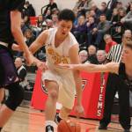 Bellevue freshman Alex Yu dribbles past defenders during a loser-out game against Lake Washington in the 3A KingCo league tournament on Feb. 11. Benjamin Olson/staff photo