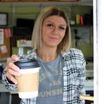 Mitchell Atencio/Staff Photo                                Above, Laura French hands a customer a drink at Megans Coffee Corner in Bellevue on Feb. 25. Below, the menu and walk-up window at Megans Coffee Corner.