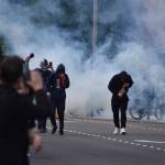 Protesters fall back from clouds of smoke and tear gas at a protest May 31 in downtown Bellevue. Photo by Haley Ausbun/Sound Publishing